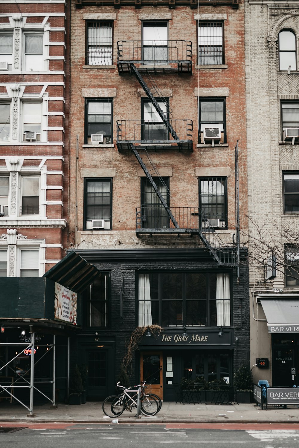 gray bicycle beside building