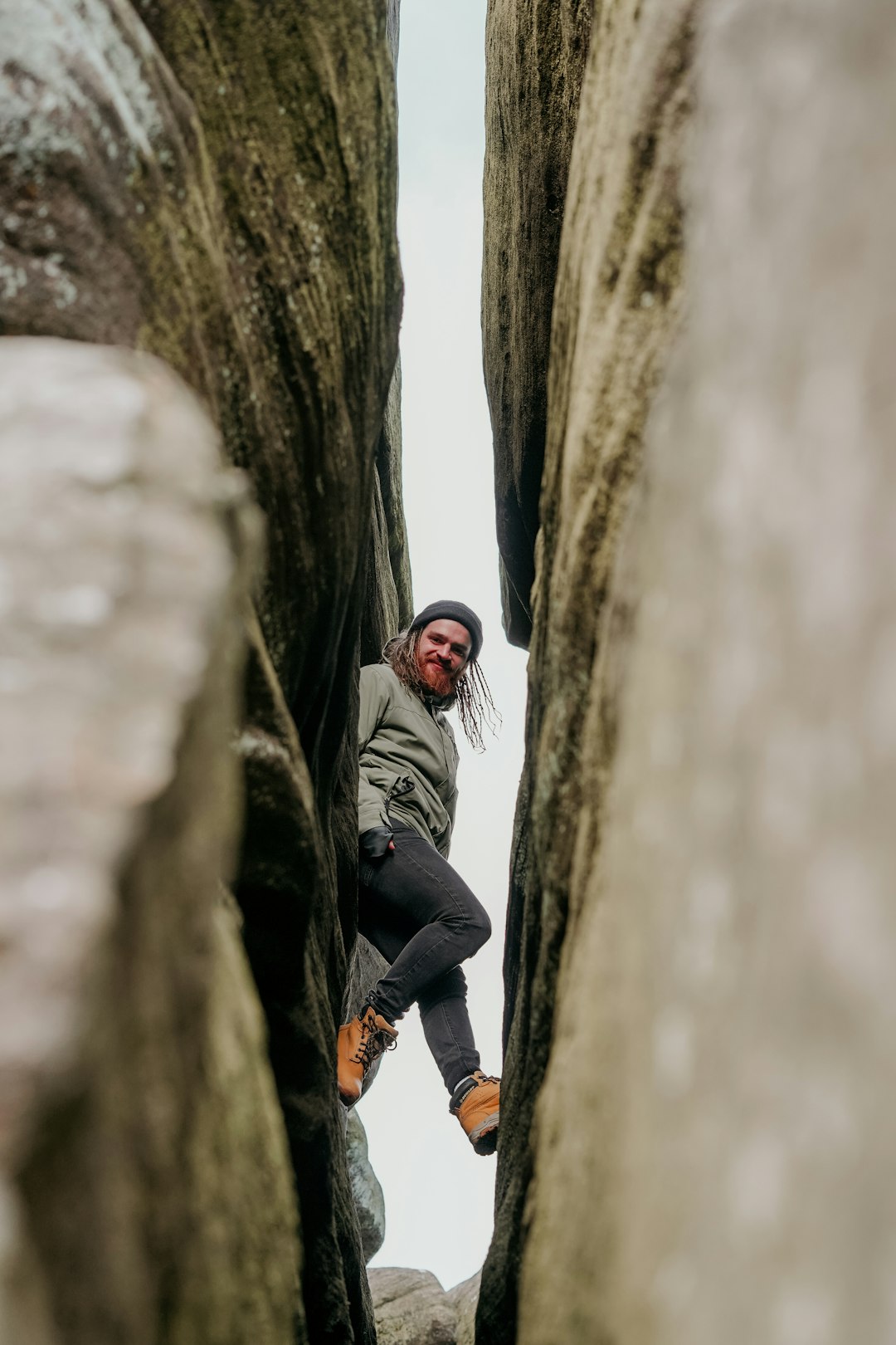 man standing between large rocks