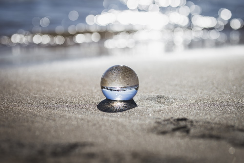 clear toy marble with reflection of seashore