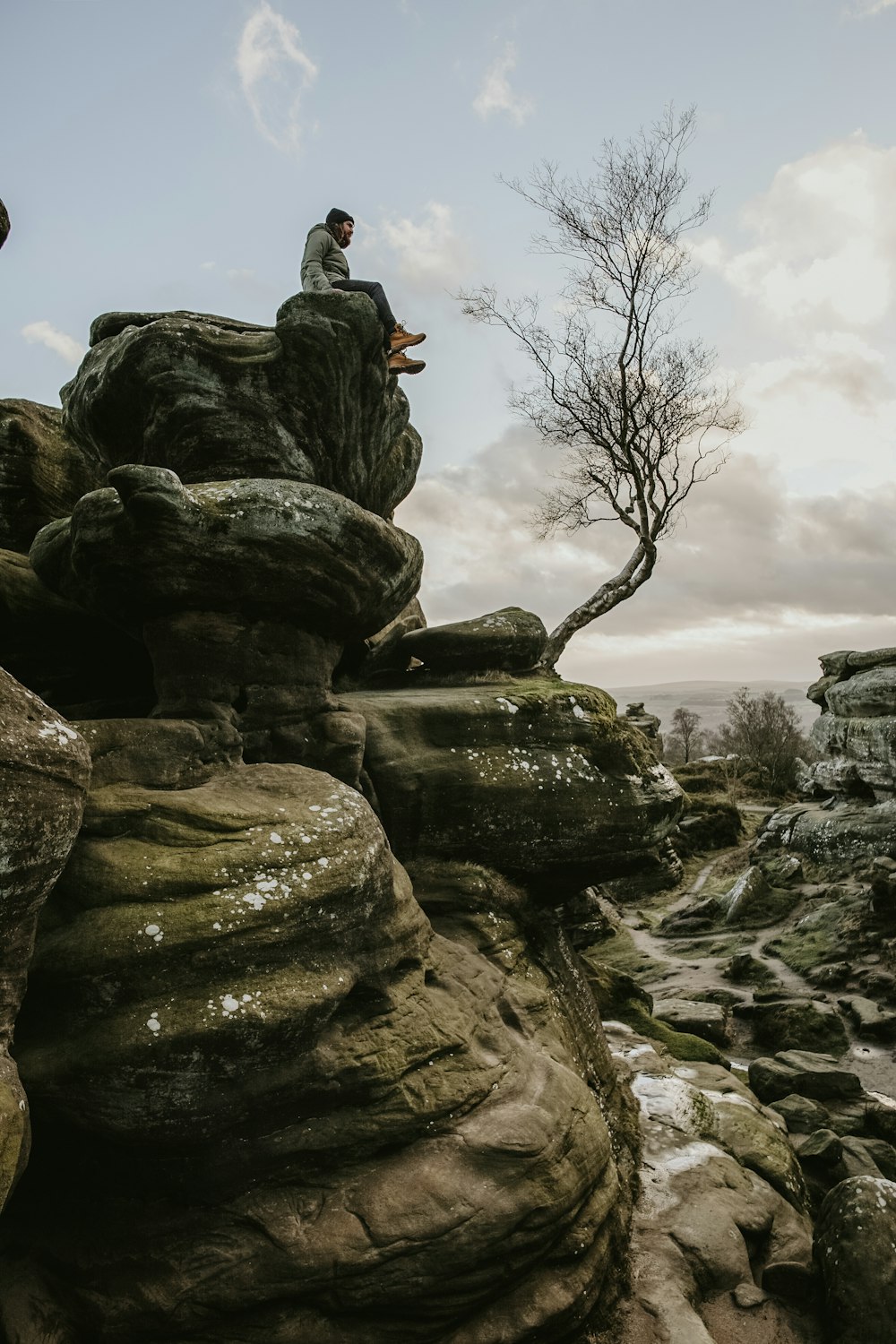 person sitting on rock formation