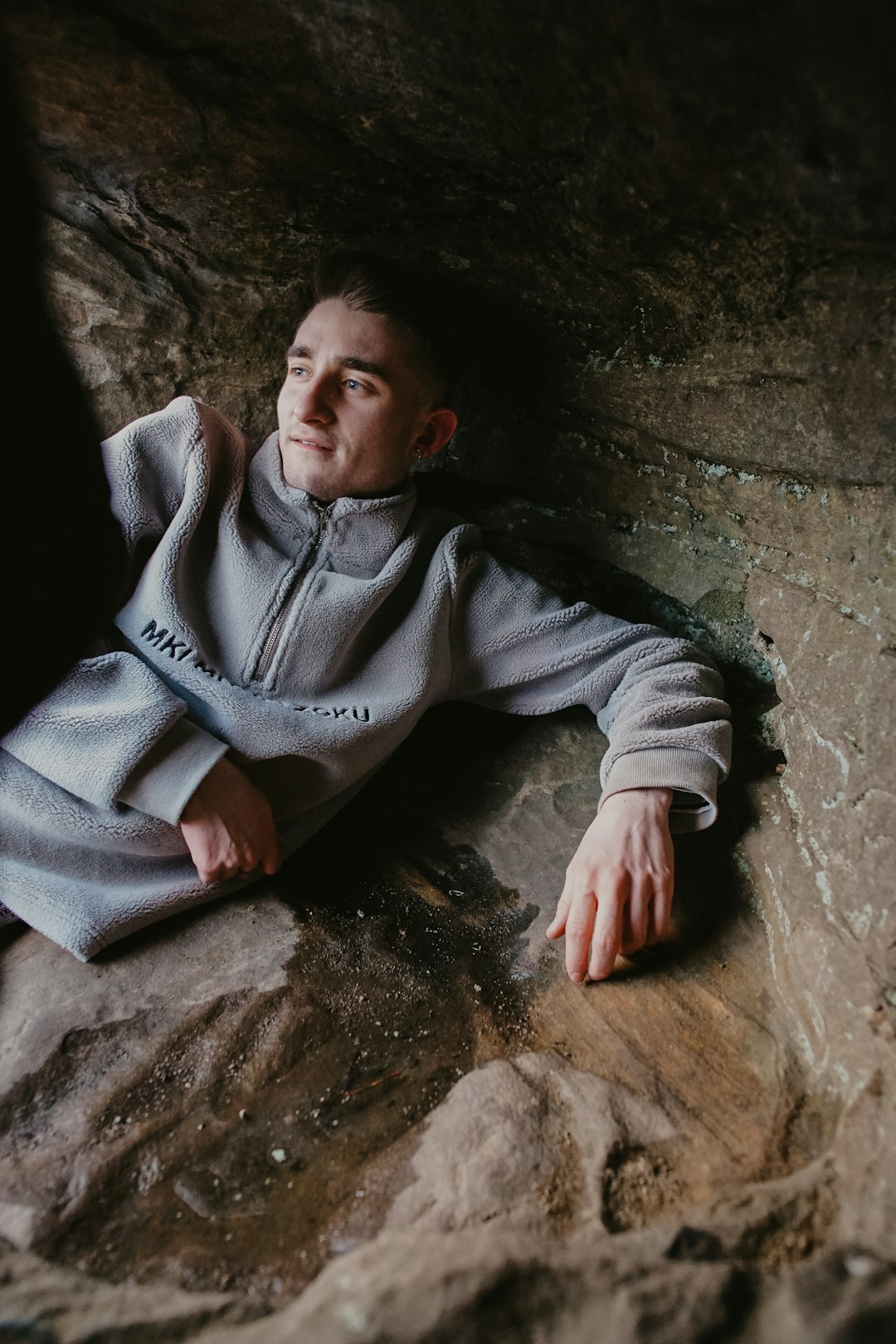 man leaning on wall