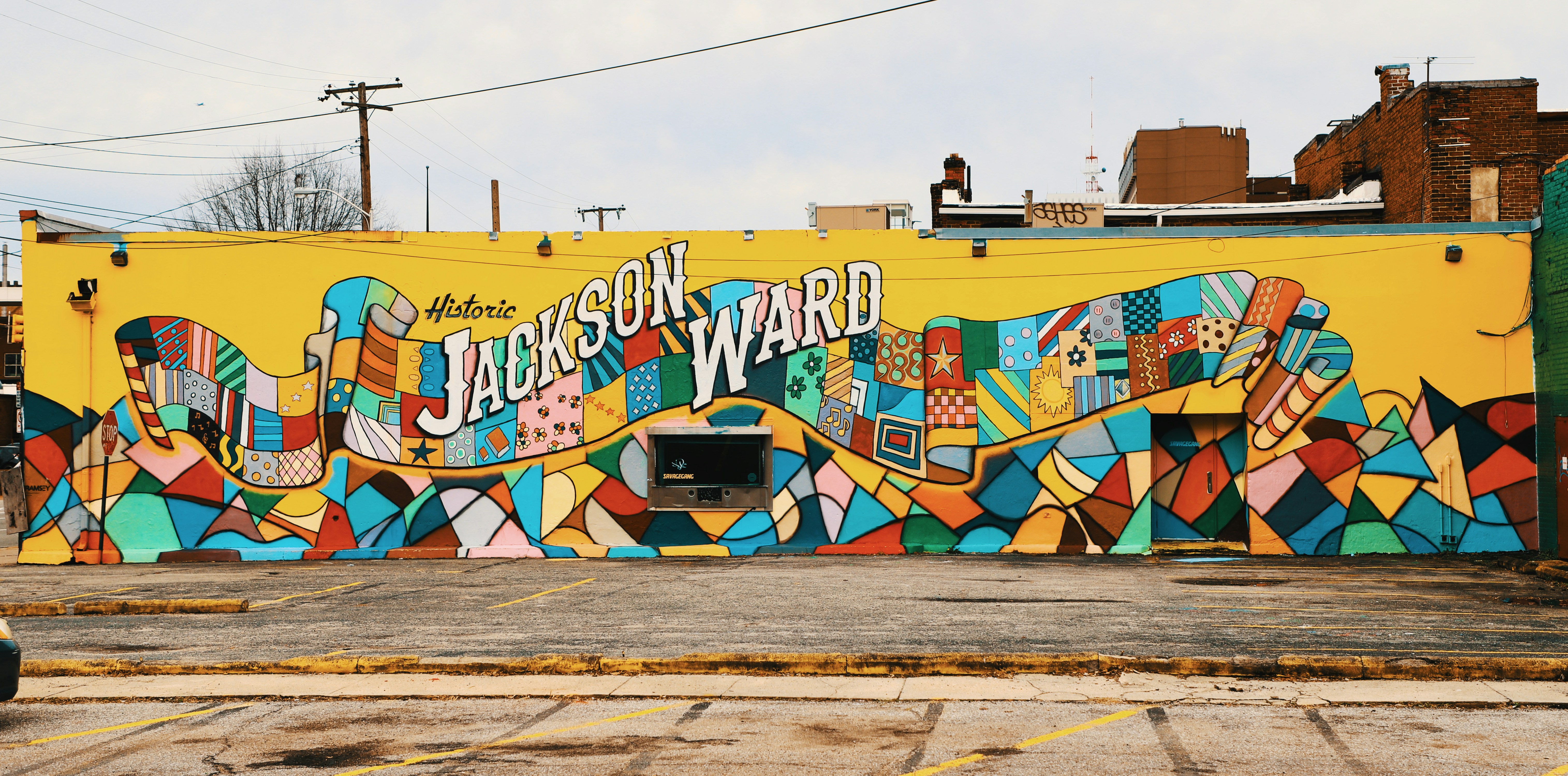 A colorful mural featuring various global cannabis slang terms