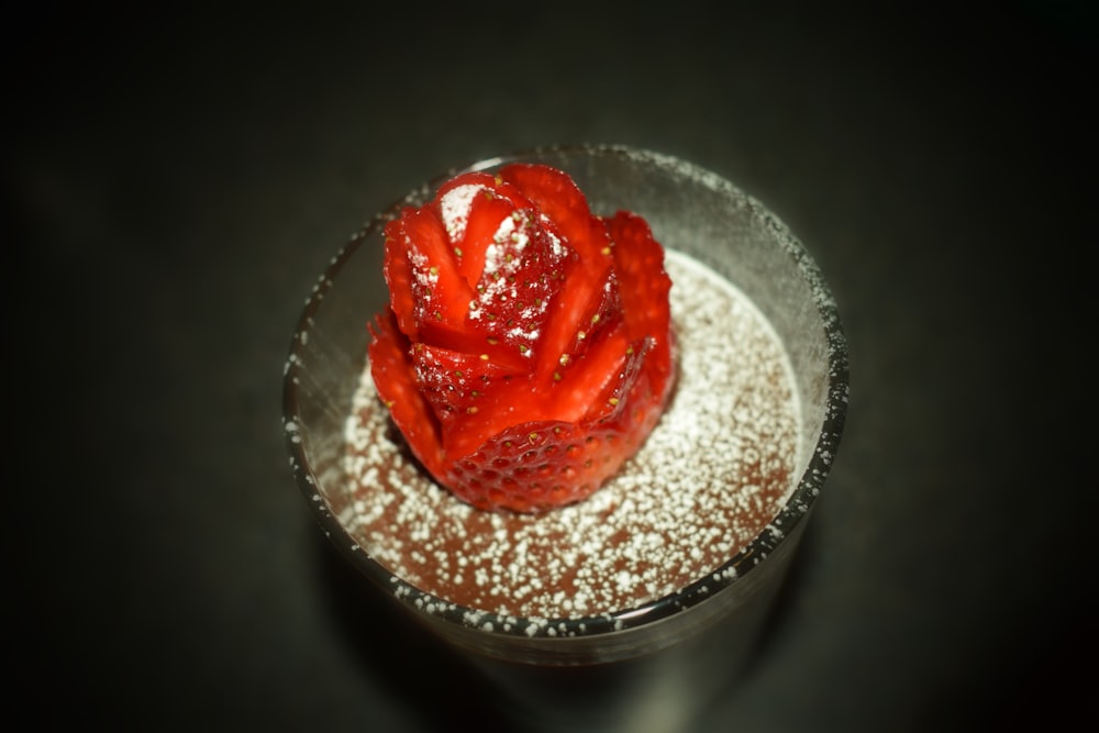 strawberry on brown liquid sprinkled with white powder