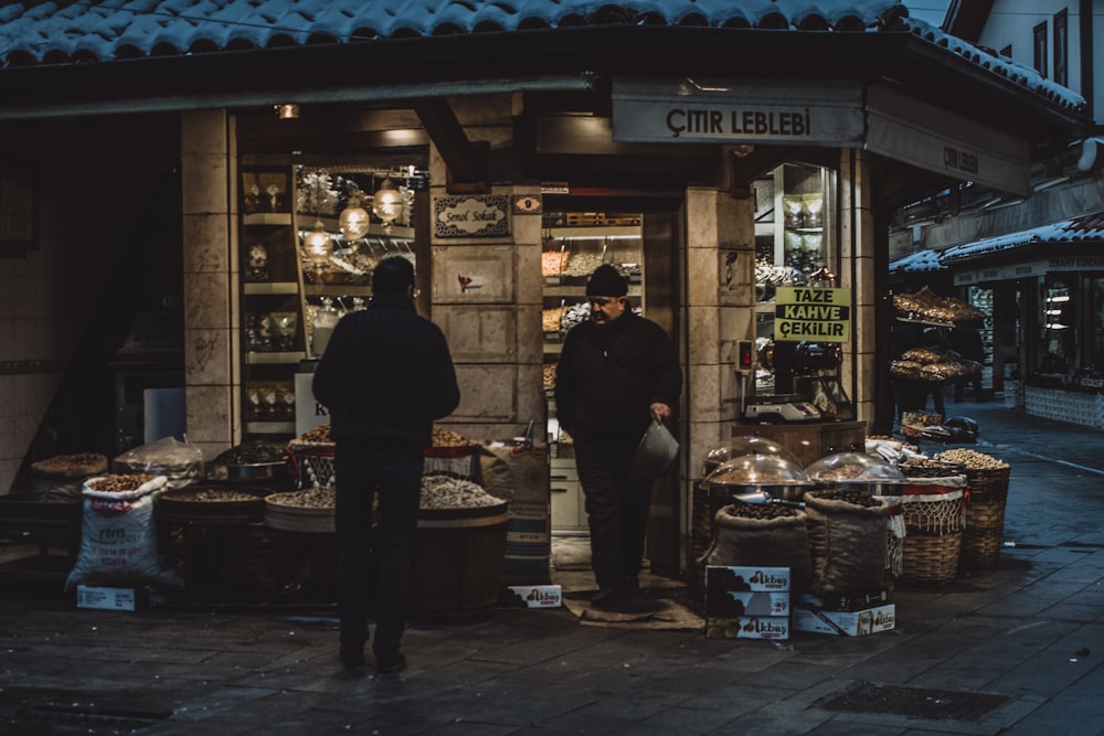 man standing in front of man standing near door