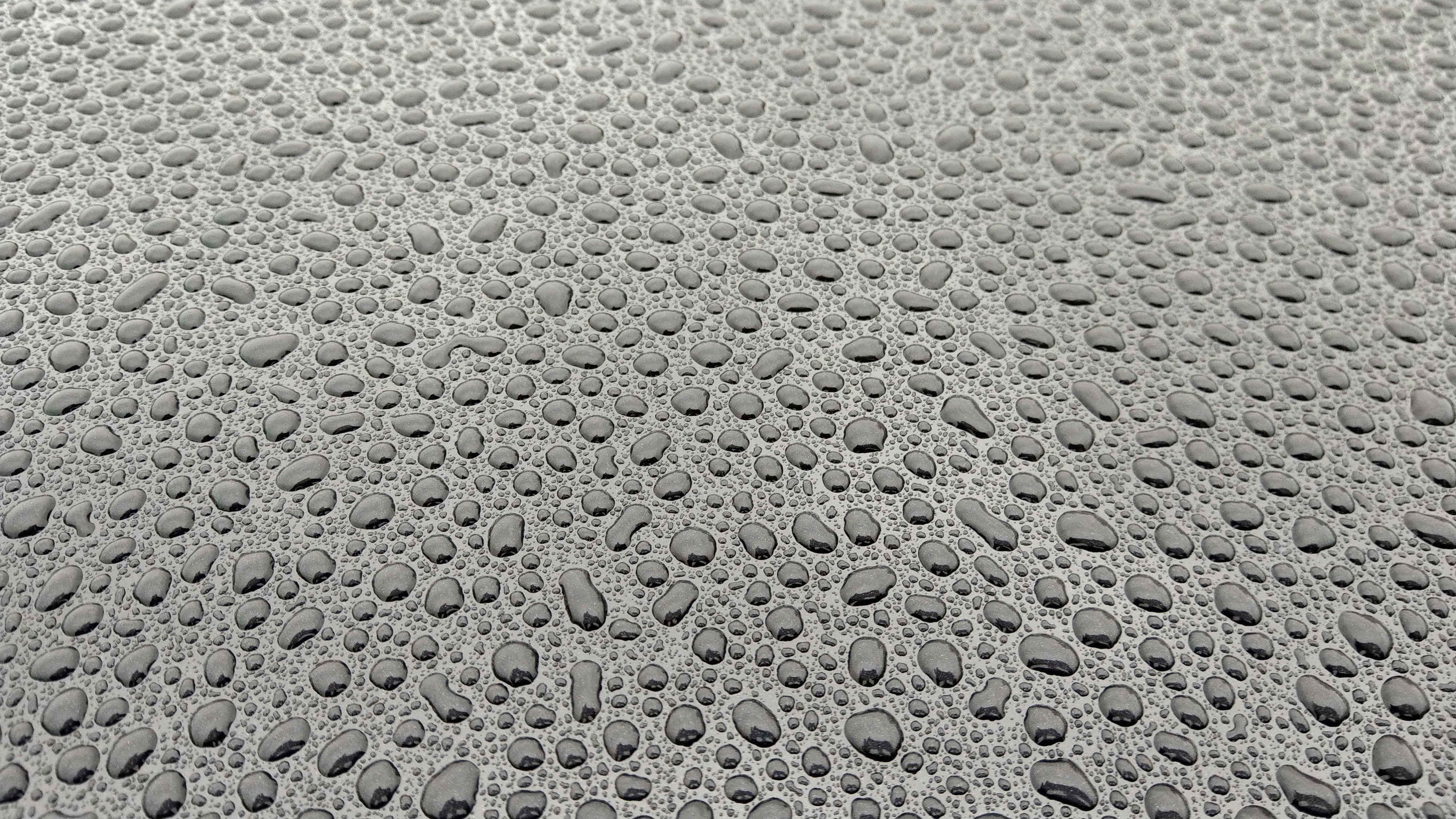 drops of water on the surface of a car