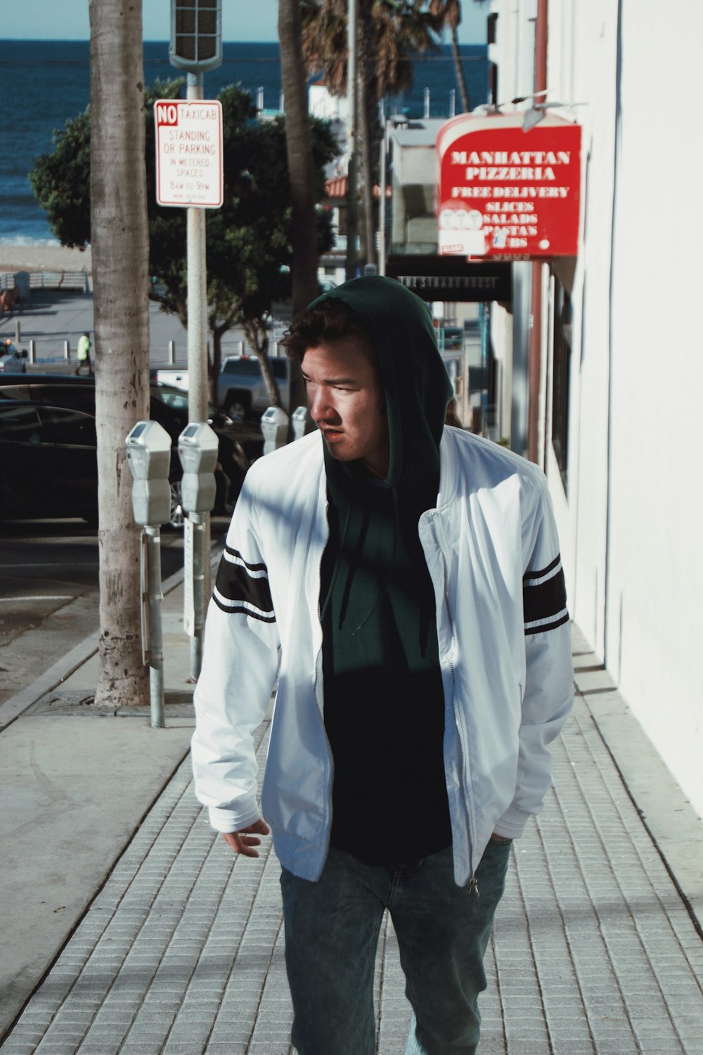 man standing beside concrete wall