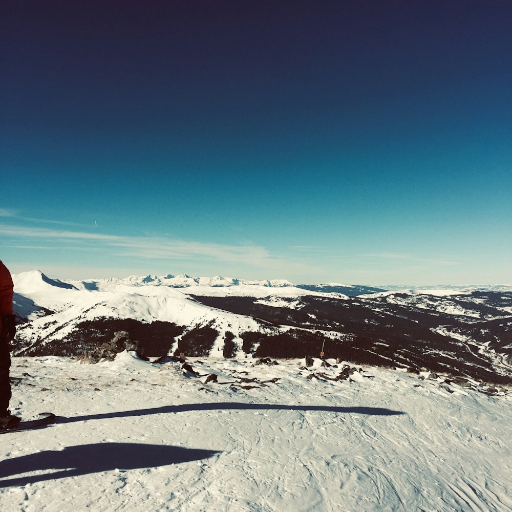 man standing at middle of field covered with snow