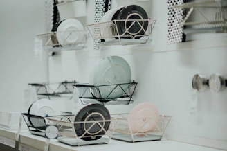 assorted-color saucers placed on rack