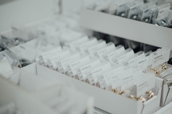 Rows of neatly organized boxes filled with packaged items labeled 'EDVALLA' displayed in an orderly fashion. The image showcases a retail or storage environment with a focus on product organization.
