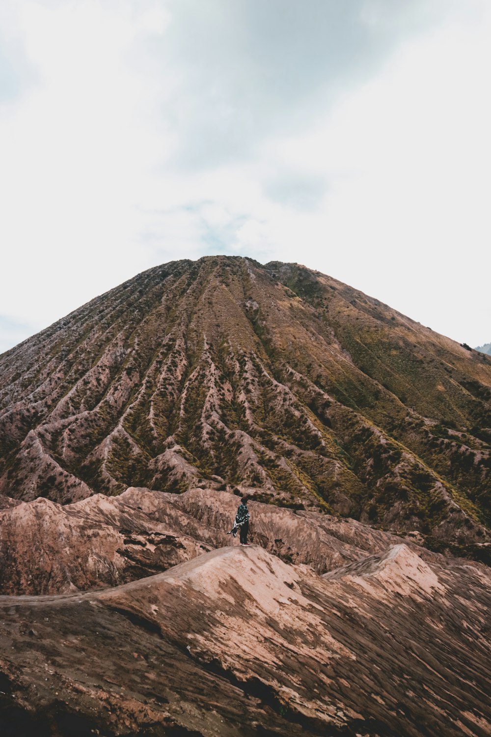 low-angle photography of person hiking mountain during daytime