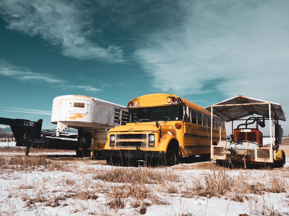 three assorted-color vehicles parked at middle of field