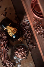 Close-up of a sleek black coffee bottle with subtle gold accents resting on a dark textured surface, illuminated by soft, cinematic lighting.