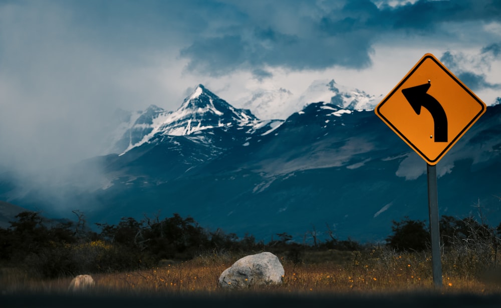 black and orange left turn arrow road signage