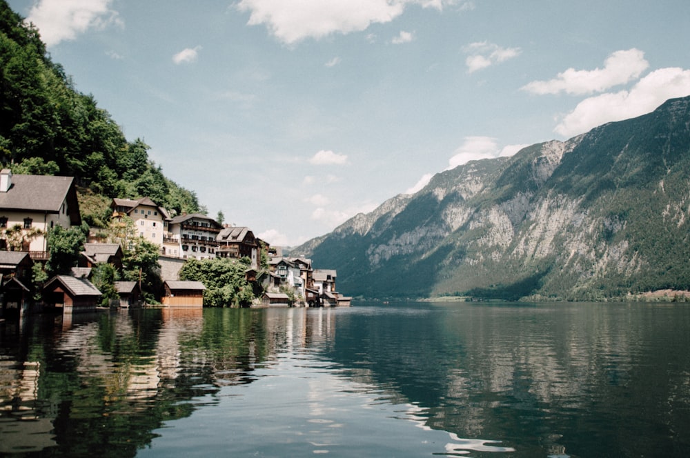 white houses near the lake and mountains photo