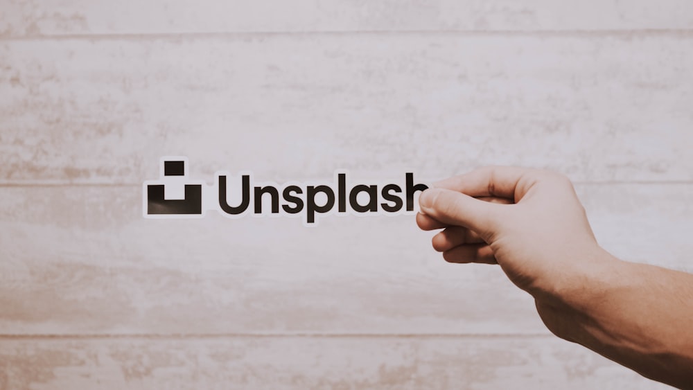 person holding Unsplash sticker