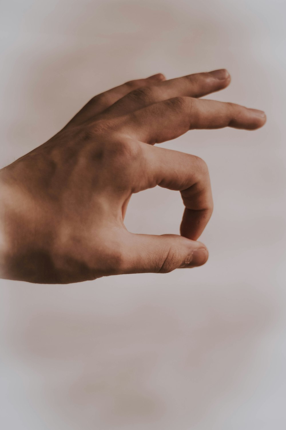 left human hand with OK sign