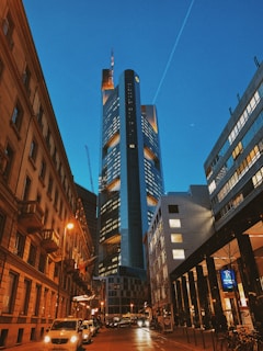 Evening view of a completed skyscraper illuminated with warm lights.