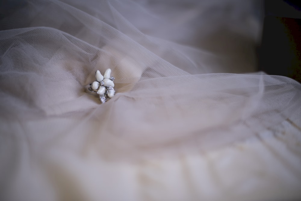 a close up of a dress with a flower on it