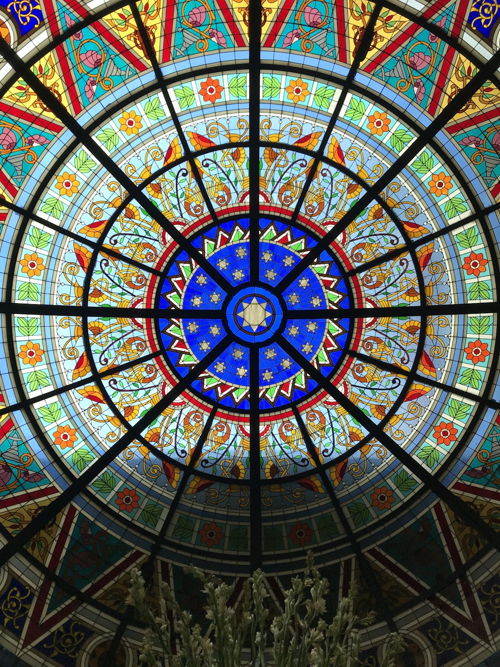 blue, green, and red floral mosaic stained glass