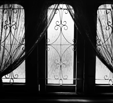 Elegant swing window with black aluminum frame in a bright room.