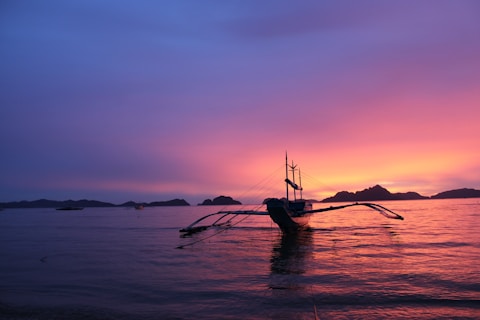 brown wooden boat at water