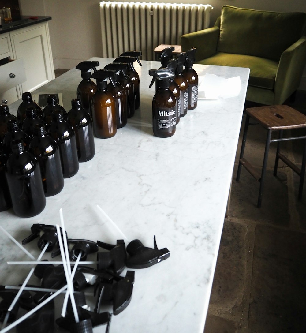 botellas de vidrio marrón sobre mesa blanca