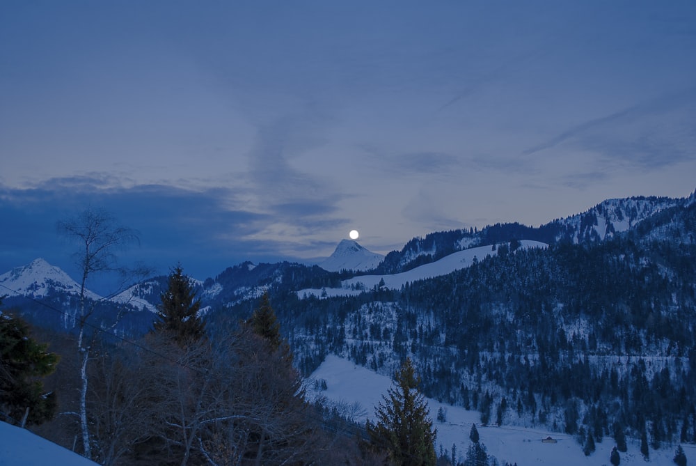 mountain range covered by snow during nighttime