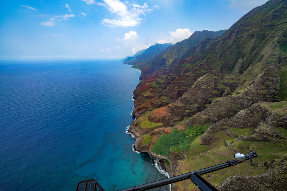 mountain and ocean during daytime