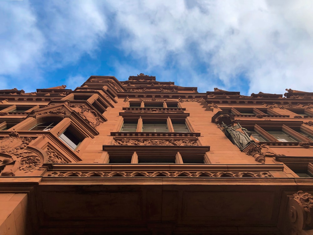 low-angle photography of brown concrete building