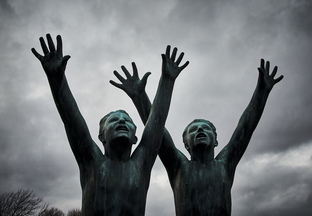 two man raising their hands