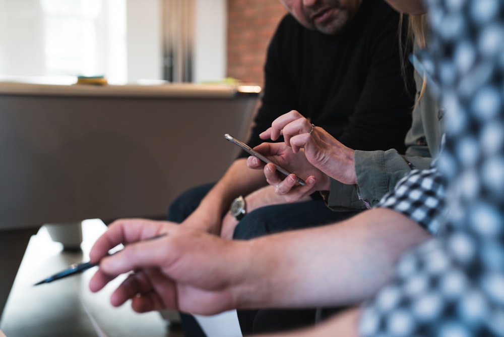 three people browsing a website using mobile device