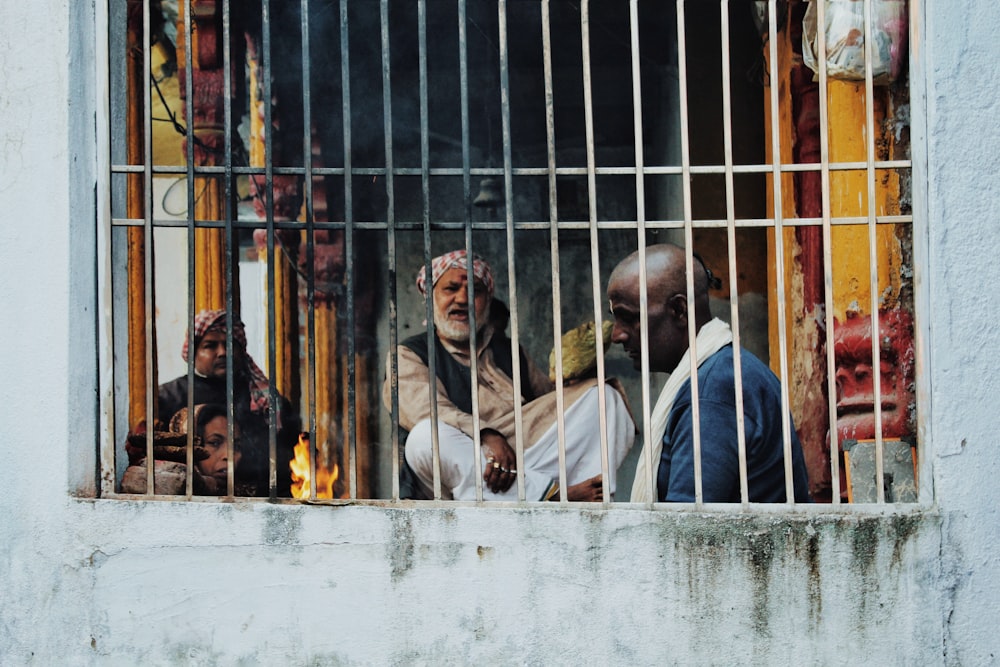 three men inside concrete building