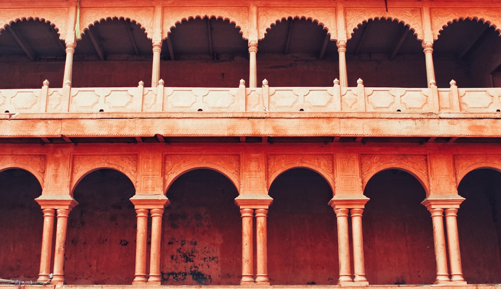 orange concrete building with pillars