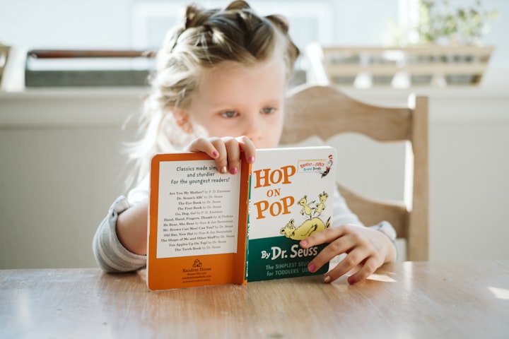 Child reading "Hop on Pop" by Dr. Seuss
