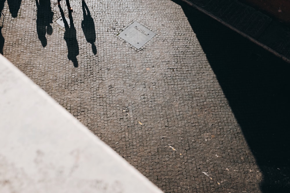 a group of people walking down a sidewalk