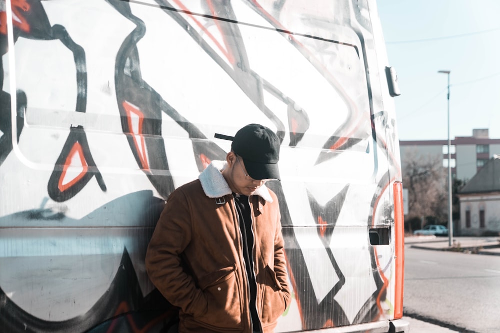 man sitting on white and orange wall