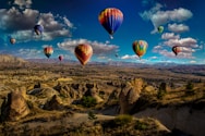 assorted-color hot air balloons over brown mountain range during daytime