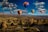 assorted-color hot air balloons over brown mountain range during daytime