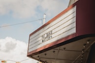 A vintage marquee sign with red trim displays the message 'THIS PLACE MATTERS' against a cloudy sky backdrop.