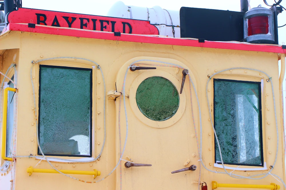 a close up of the side of a yellow boat