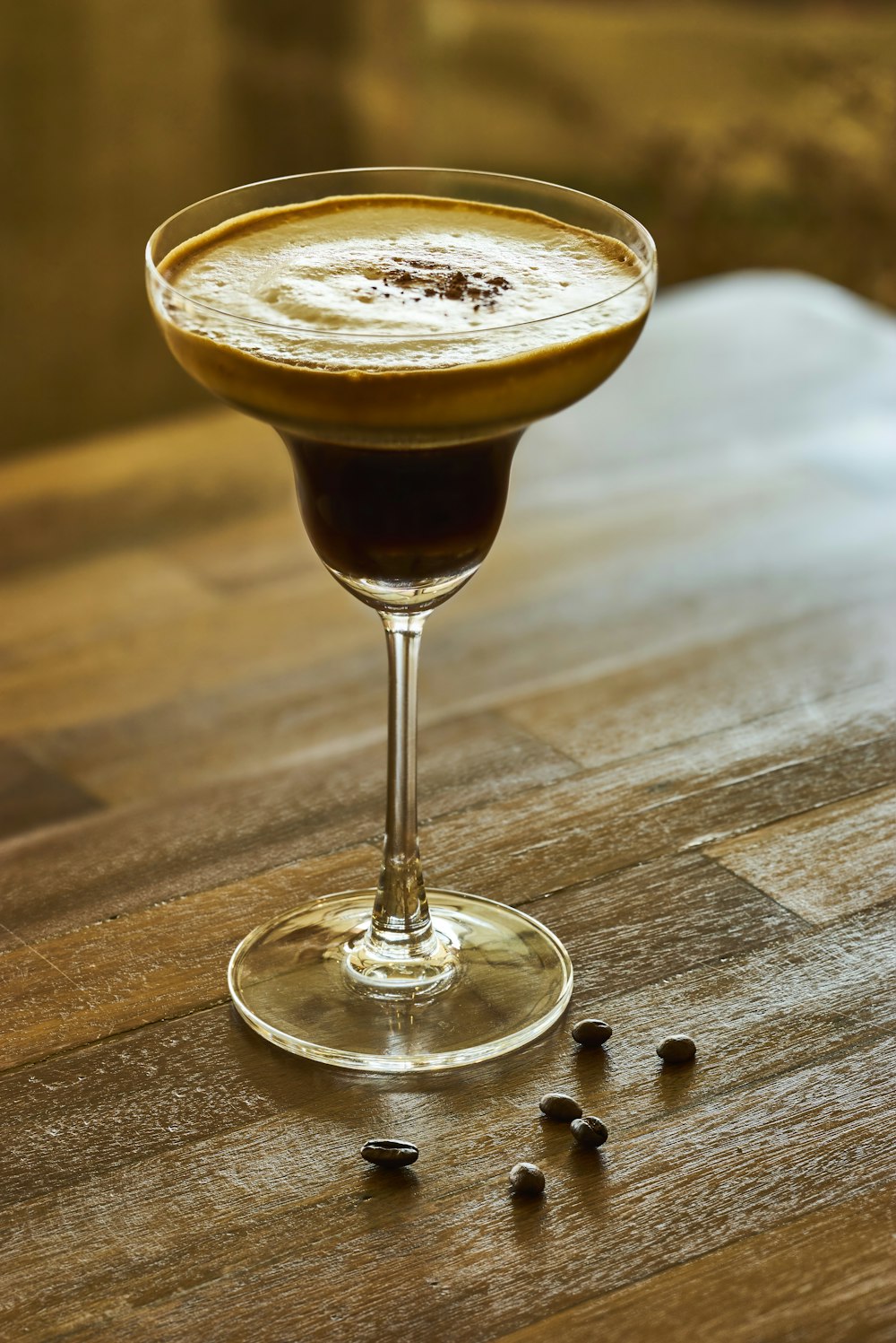 cocktail glass filled with brown beverage