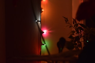 Colorful smart bulbs glowing softly in a living room setting at dusk.