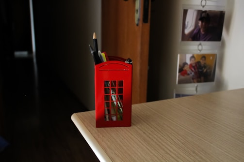 A welcoming office desk with a phone, notepad, and a small Welsh flag.
