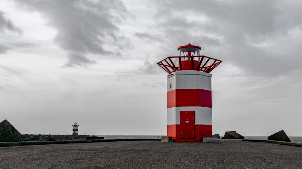 white and red striped lighthouse under white skies