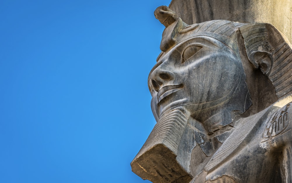 man statue under blue sky