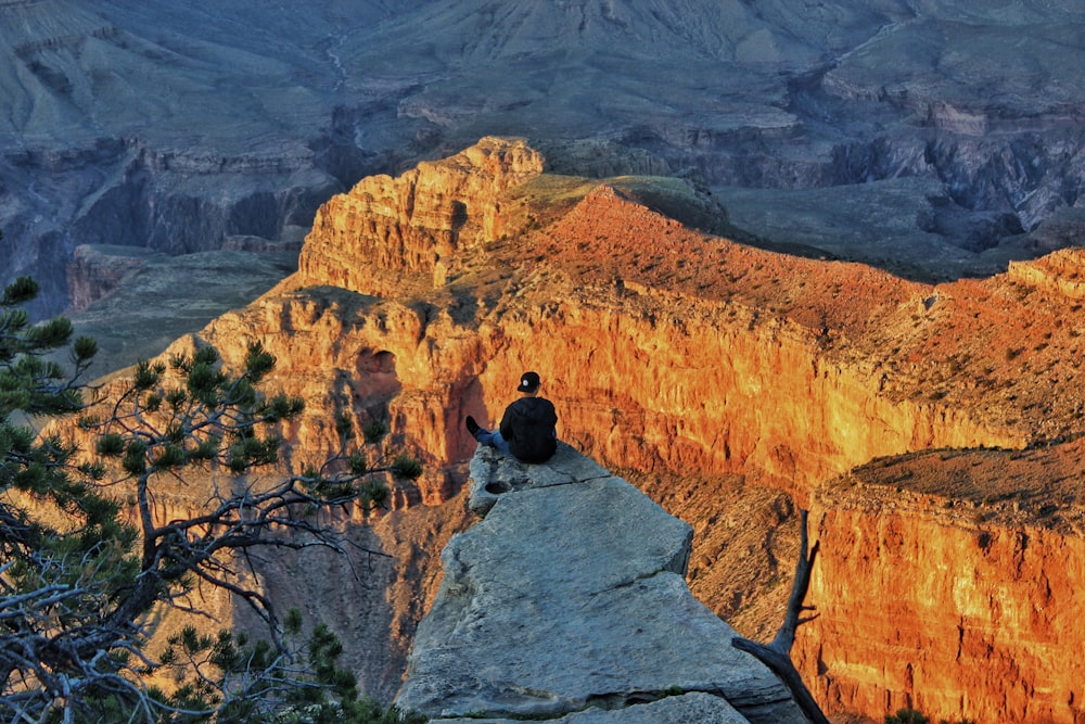 man sitting on a cliff