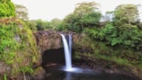 A stunning waterfall cascading into a crystal-clear pool.