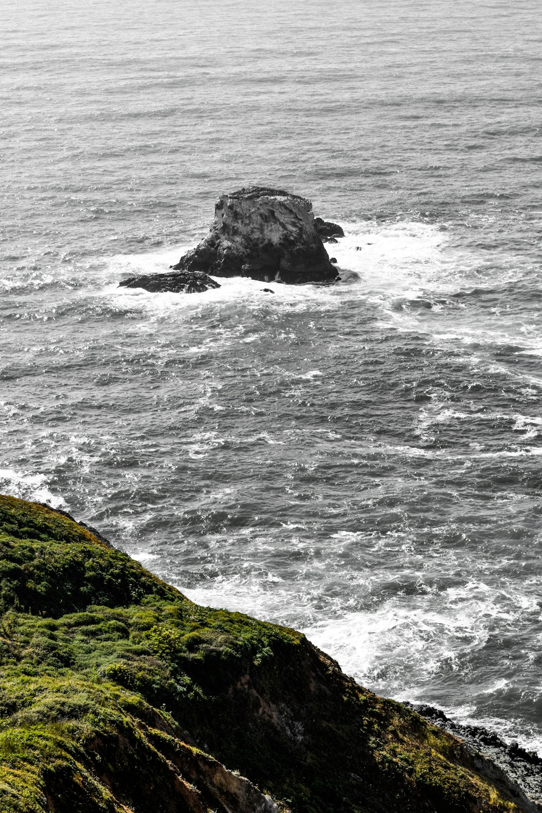 rock formation in the middle of the sea