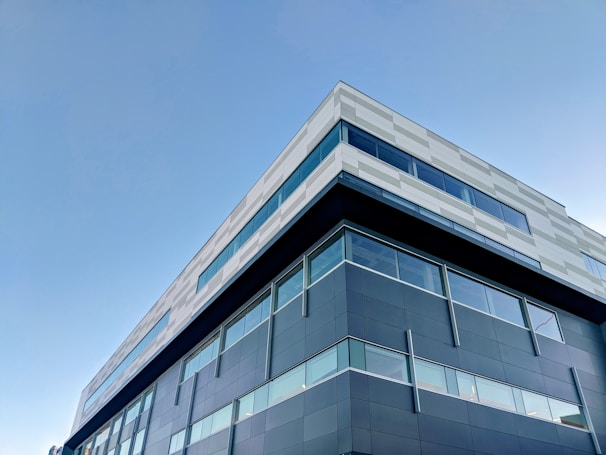A modern office building with a blue and grey facade.