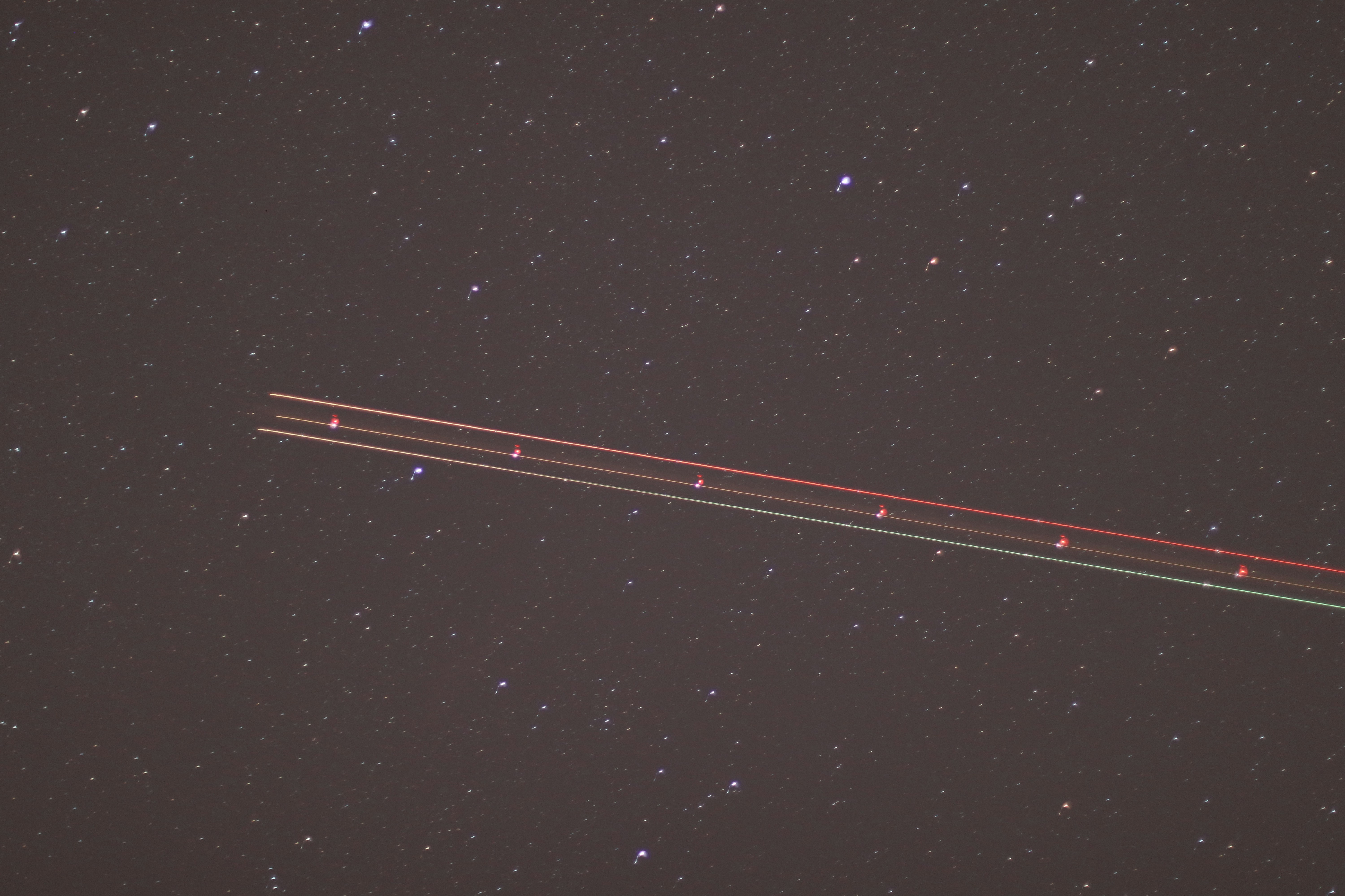 an airplane is flying through the night sky